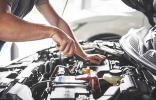 muscular car service worker repairing vehicle 1